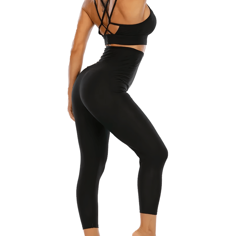 Woman wearing black high-waist thermal leggings with adjustable fit, perfect for enhanced workout performance.