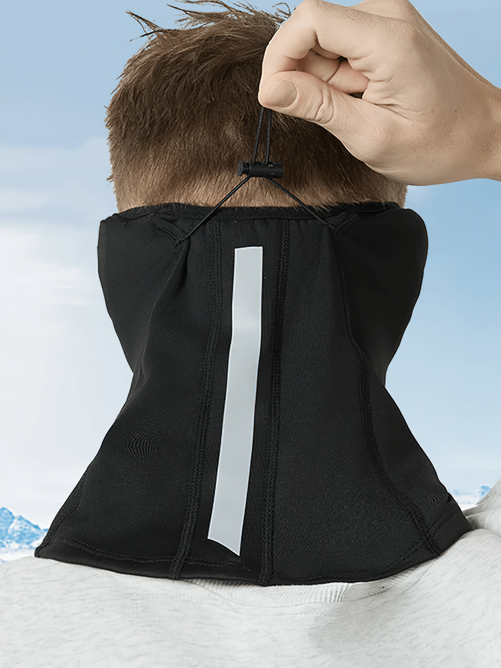 Adjustable thermal neck gaiter with over-ear coverage and buckle fit, ideal for winter activities in cold weather. Breathing feature.