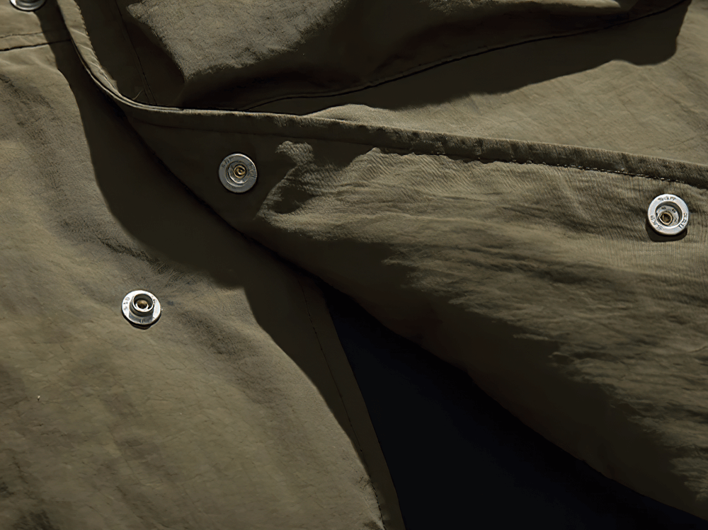 Close-up of nylon duck down vest with button detail, highlighting durable fabric and craftsmanship, ideal for outdoor casual style.