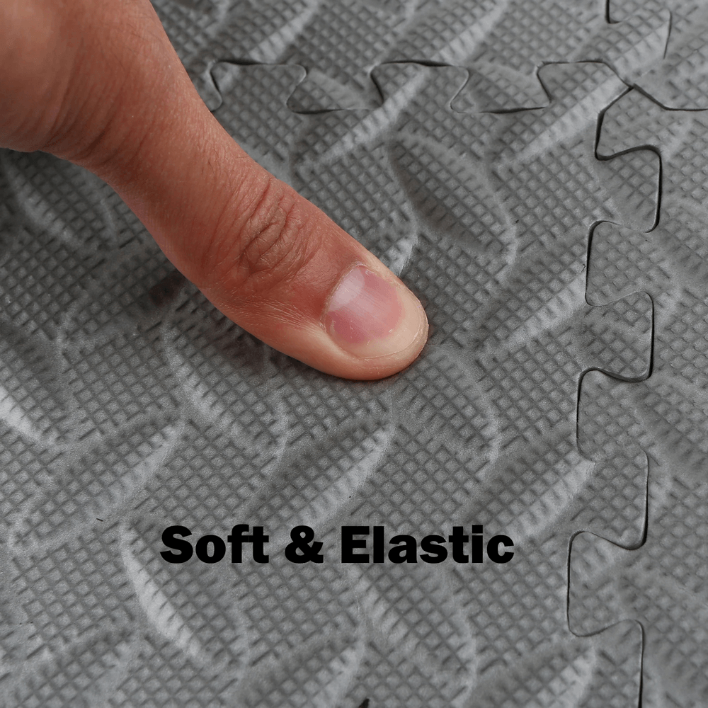 Close-up of finger pressing Thick EVA Foam Exercise Mats for Indoor Flooring - SF3464 highlighting soft texture and interlocking design.