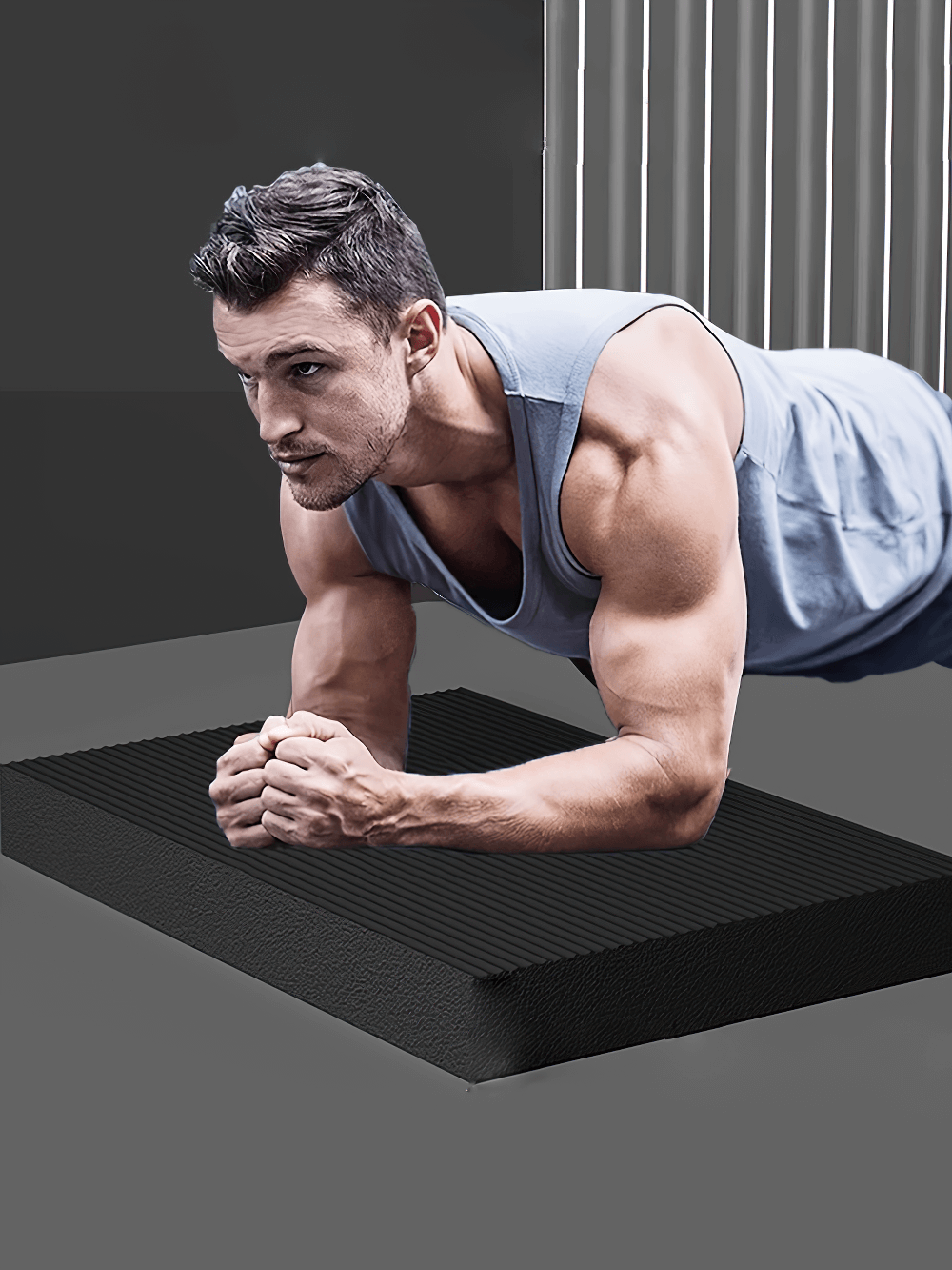 Man performing plank on thick black NBR yoga balance mat for stability and support during workouts.