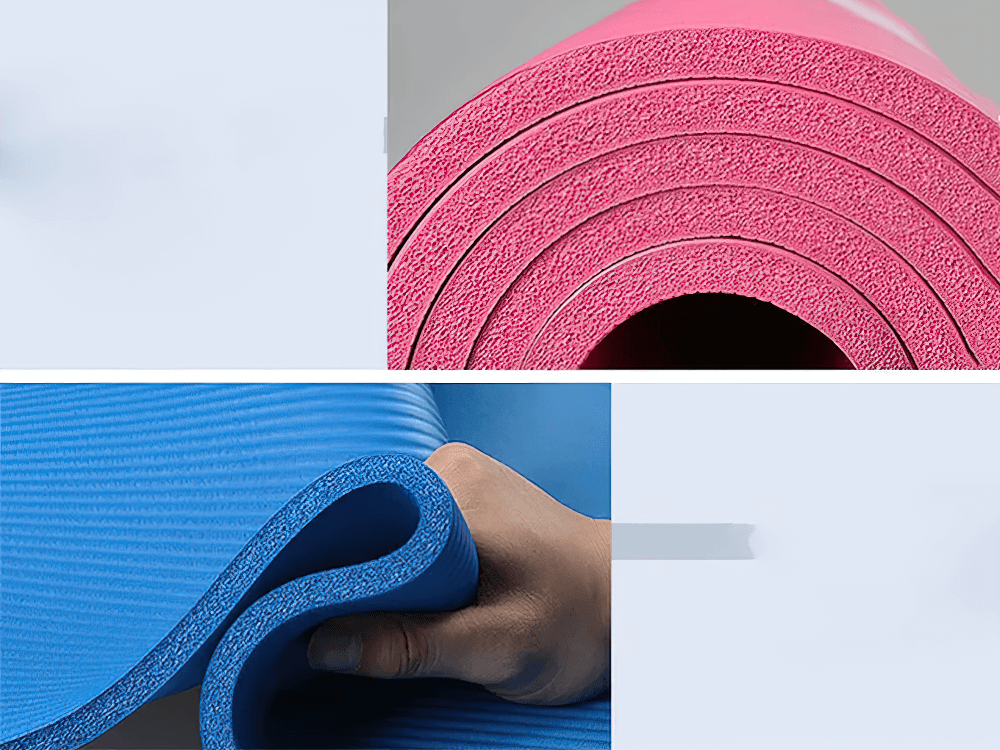 Close-up of thick, non-slip yoga and Pilates mats in pink and blue, showcasing durability and texture for superior floor exercise support.