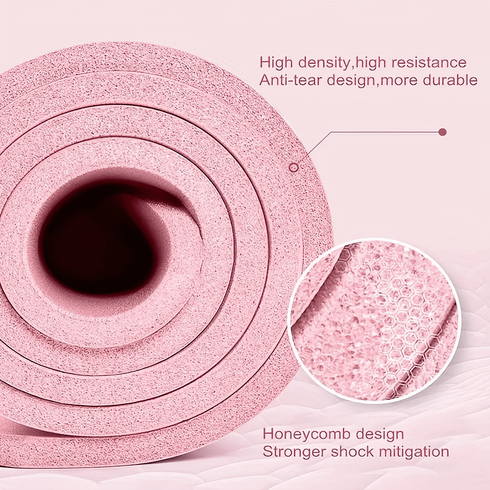 Close-up of rolled pink non-slip yoga mat with honeycomb design for shock mitigation and durability.