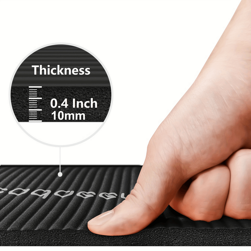 Close-up of a hand pressing down on a 0.4-inch thick non-slip yoga mat, showing texture and grip design for stability.