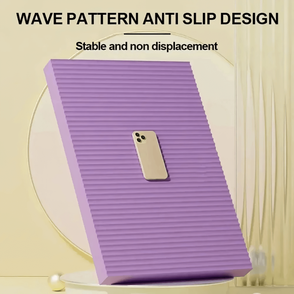 Purple yoga mat with wave pattern anti-slip design showcasing stability with a phone balancing on it.