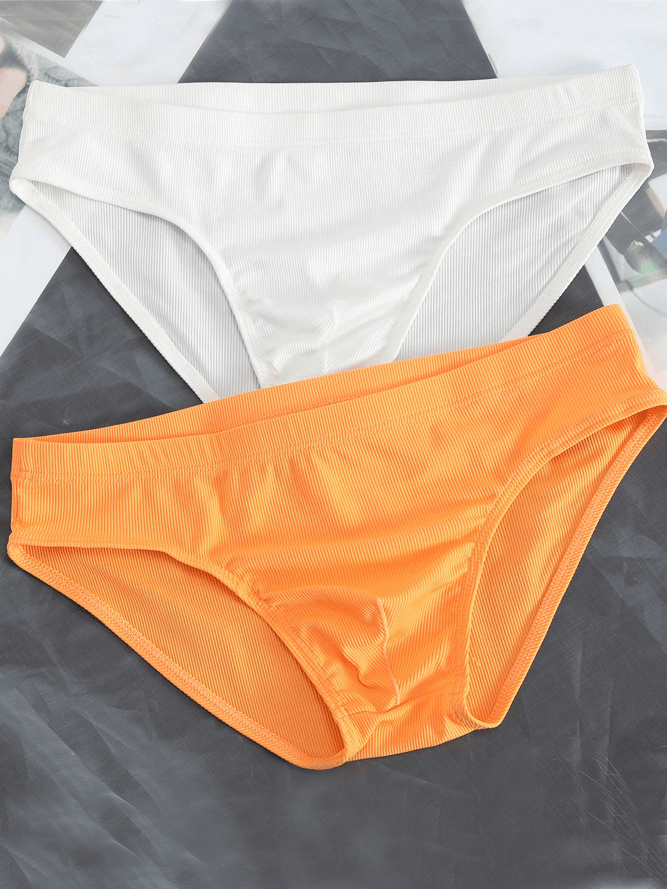Thin breathable ribbed men's briefs in white and orange, casual low-rise underwear for comfort and style.