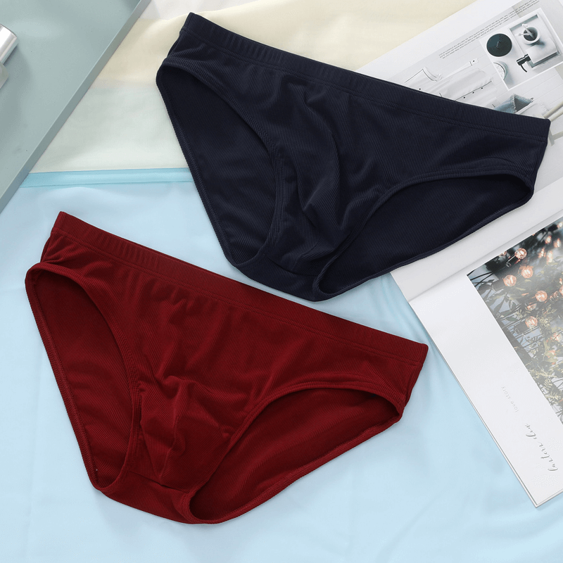 Thin breathable ribbed briefs for men in navy blue and red, low-rise waist, perfect for casual wear, displayed on a light surface.