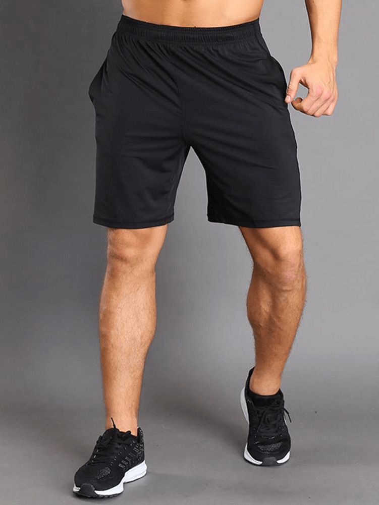Male athlete wearing thin breathable workout shorts, perfect for running. Quick-drying black shorts with drawstring, style SF1480.