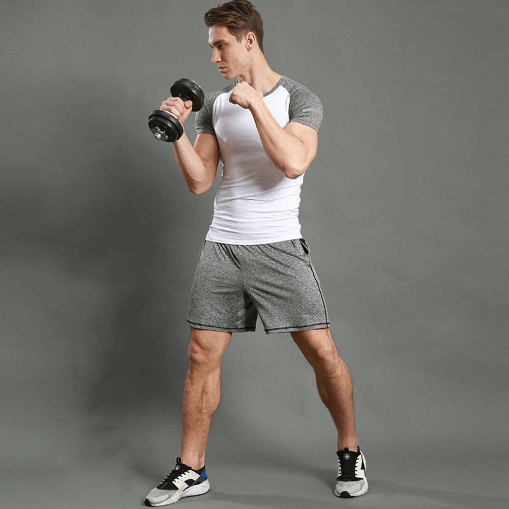 Man exercising in thin breathable quick dry workout shorts, gray with drawstring, ideal for running and intense athletic activities.