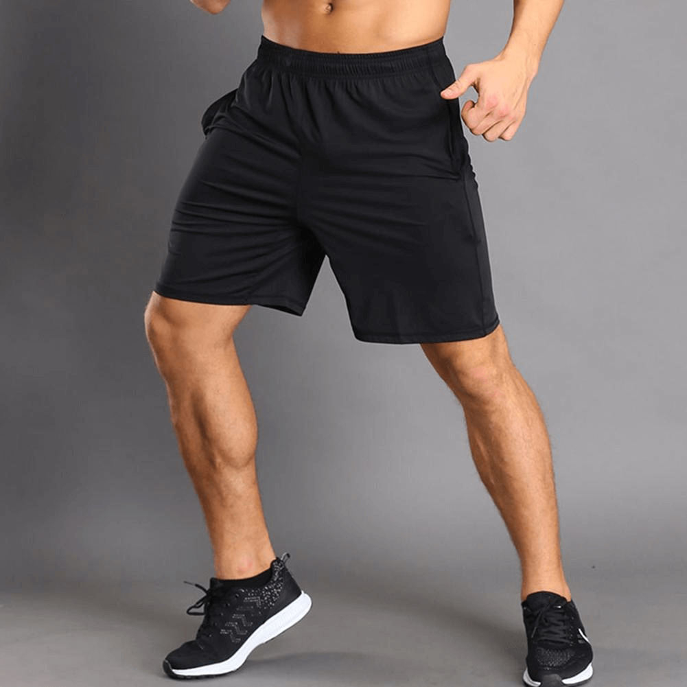 Man wearing thin breathable black workout shorts, showcasing lightweight quick-dry design for running and sports. Stylish and comfortable fit.
