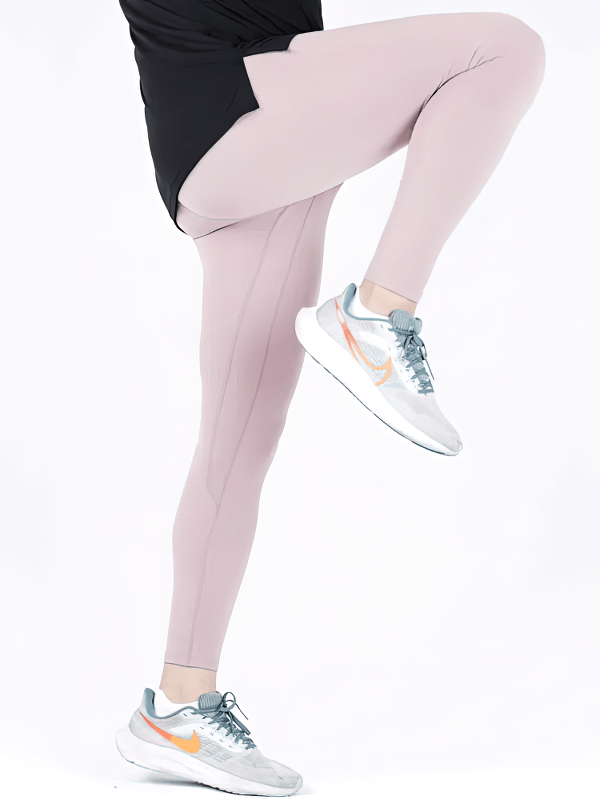 Man wearing tight breathable high rise workout leggings performing a high knee exercise in stylish sneakers, showcasing flexibility.