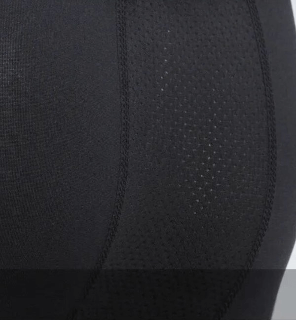 Close-up of black tight compression men's running leggings featuring breathable, quick-drying fabric, ideal for athletics and workouts.