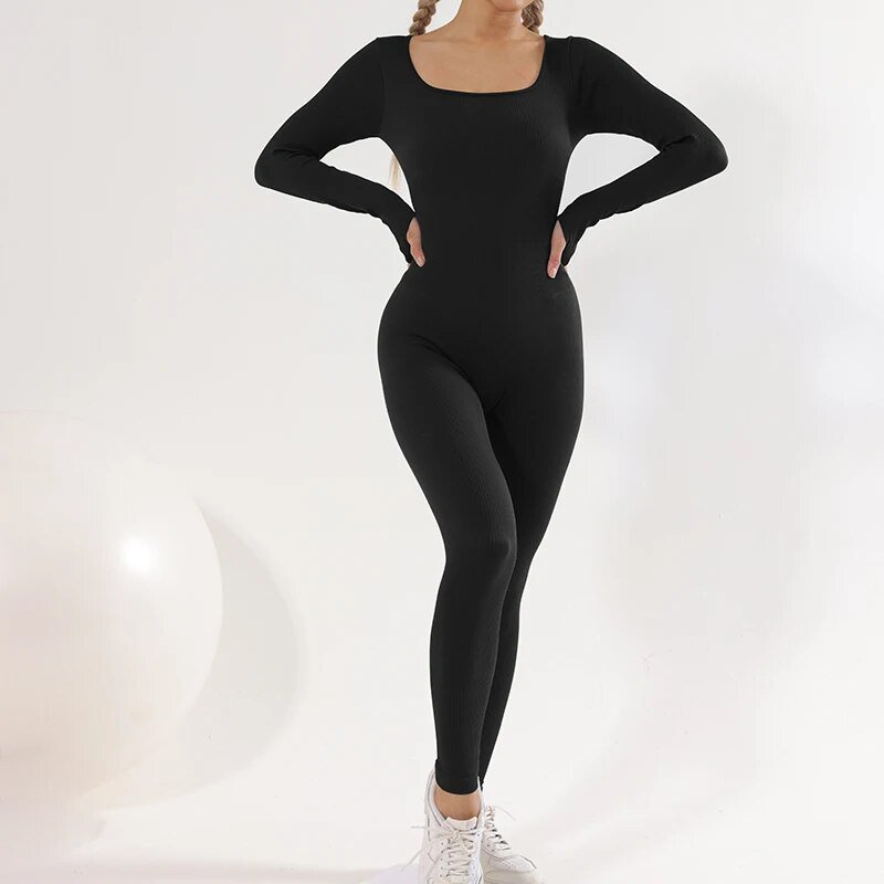 Woman in black tight elastic one-piece sports jumpsuit, showcasing full sleeves and stretch fit, perfect for yoga. SF1680 model.
