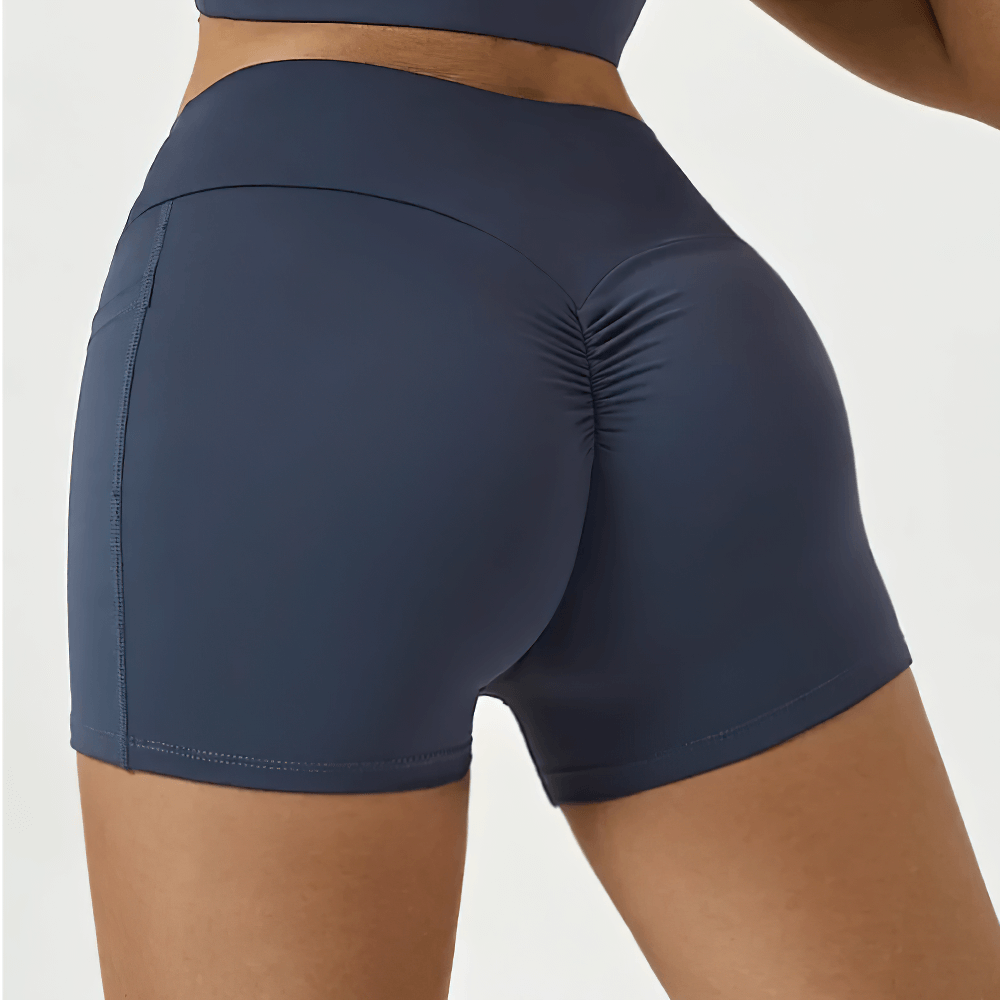 Woman wearing Tight Fitting High Waisted Scrunch Yoga Shorts - SF4119 with butt lifting design and side pockets, ideal for active women.