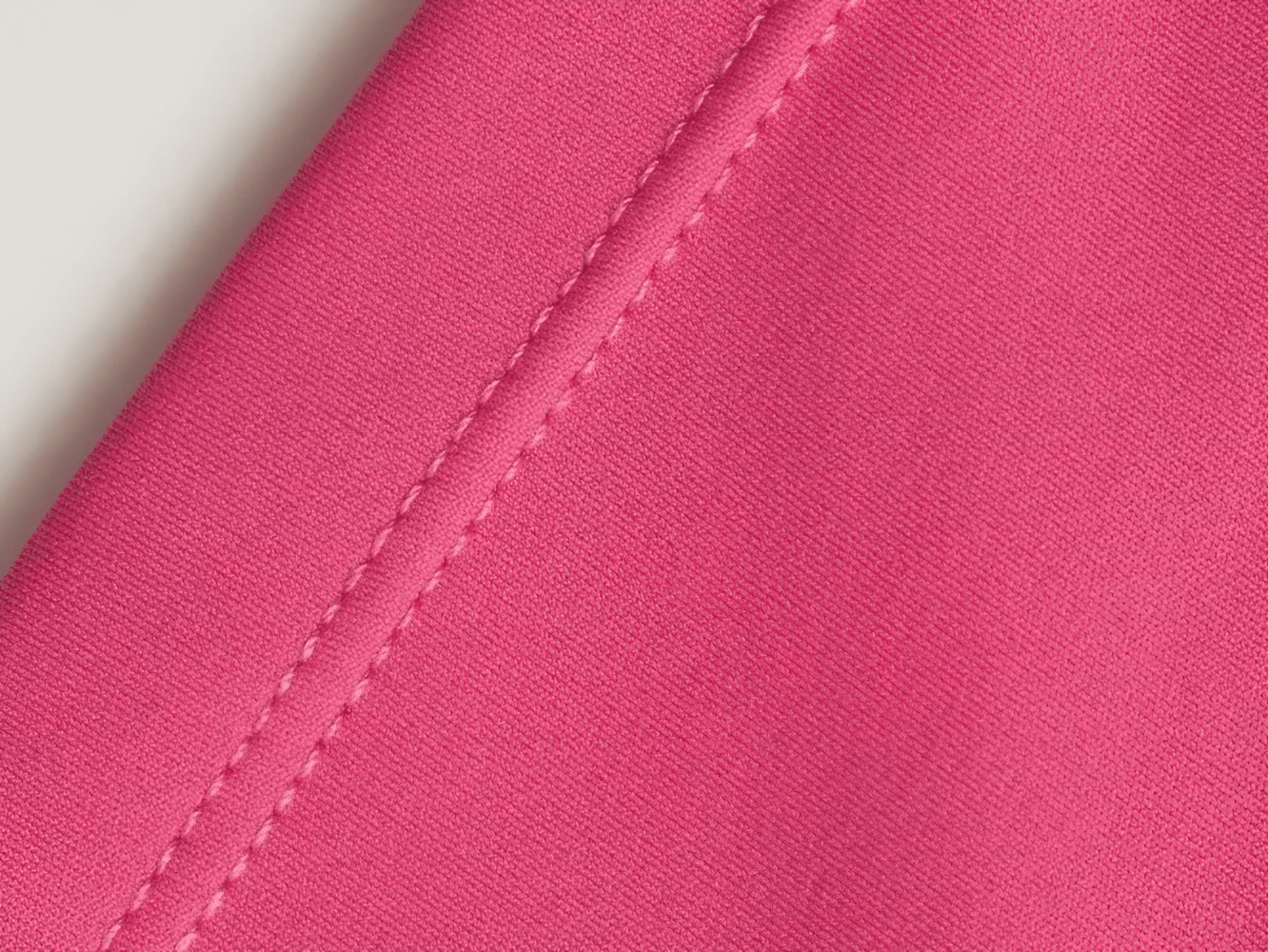 Close-up of pink fabric detail on Tight Fitting High Waisted Scrunch Yoga Shorts - SF4119, showcasing stitching and texture.