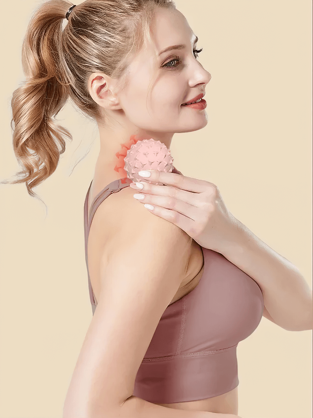 Woman using TPE yoga massage ball for shoulder muscle relaxation and trigger point relief.