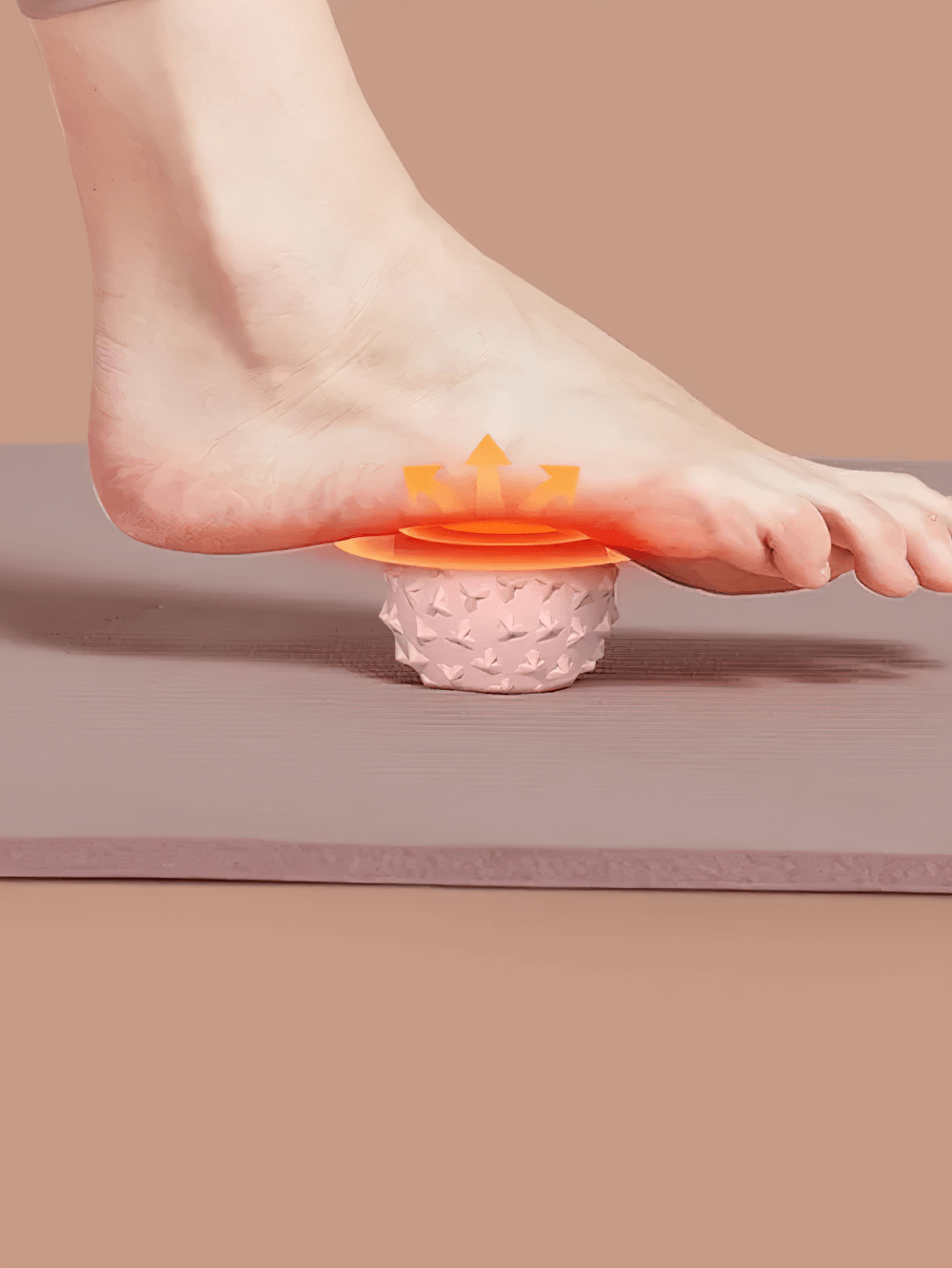 Foot using TPE mini yoga massage ball for trigger point relief and muscle relaxation on mat.