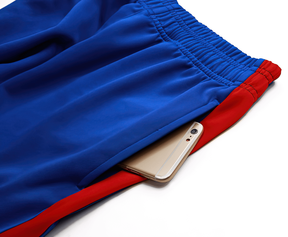 Blue and red men's running pants with a smartphone in the pocket, showcasing breathable and elastic material for comfortable training.