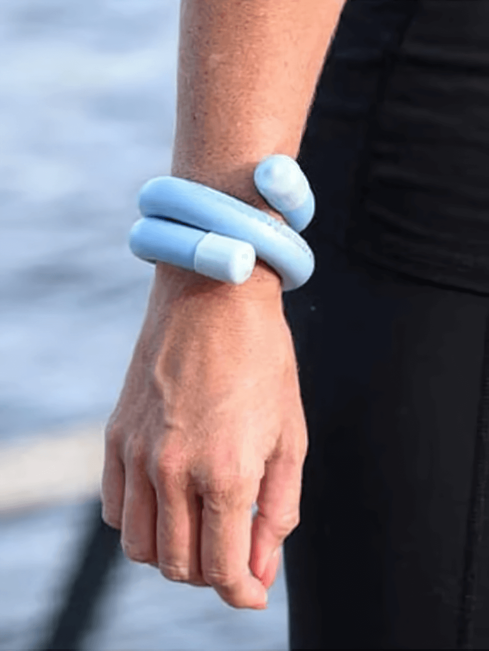 Person wearing blue adjustable waterproof wrist and ankle weight bracelet for yoga and home workouts, SF3356 featured.