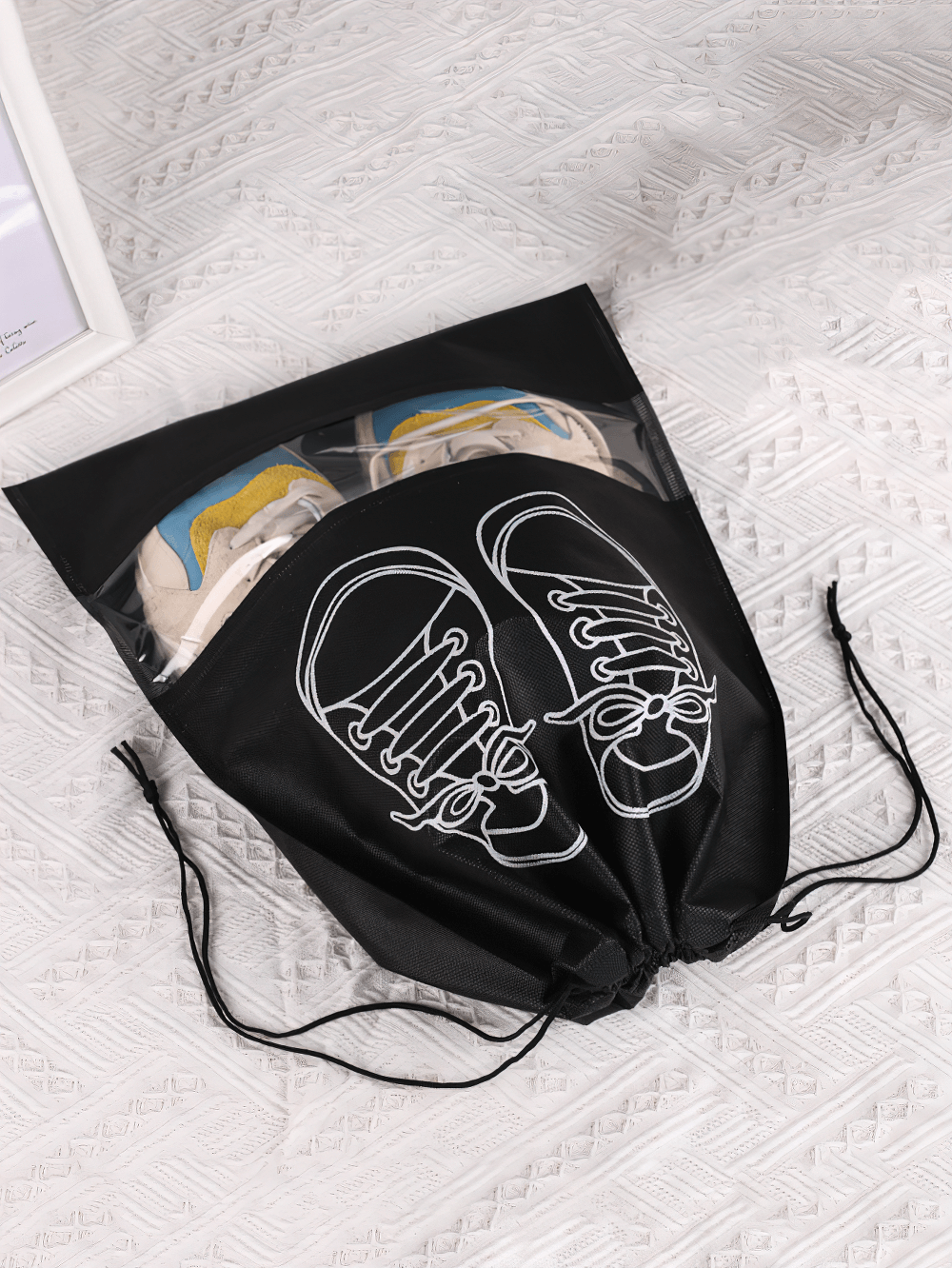 Durable transparent drawstring shoe bag with sneakers inside on a patterned surface, ideal for travel organization SF2672.