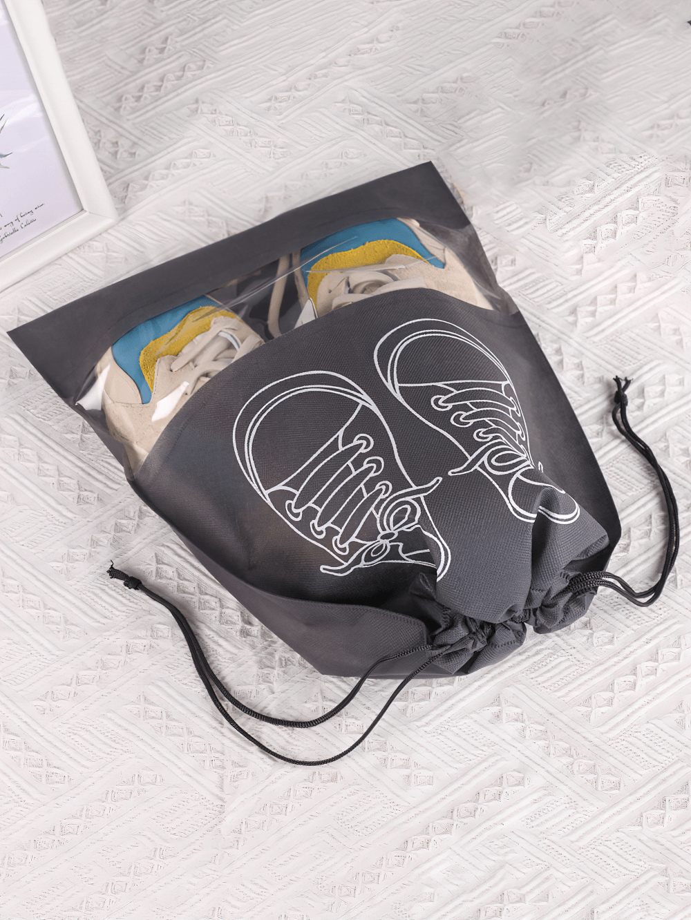 Transparent drawstring shoe bag with clear panel, holding colorful sneakers. Ideal travel organizer SF2672 for clean and dust-free shoes.