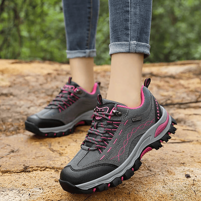 Trekking Women's Sneakers with Lace-up on rocky trail, ideal for hiking. Durable and comfy shoes with rubber outsoles.