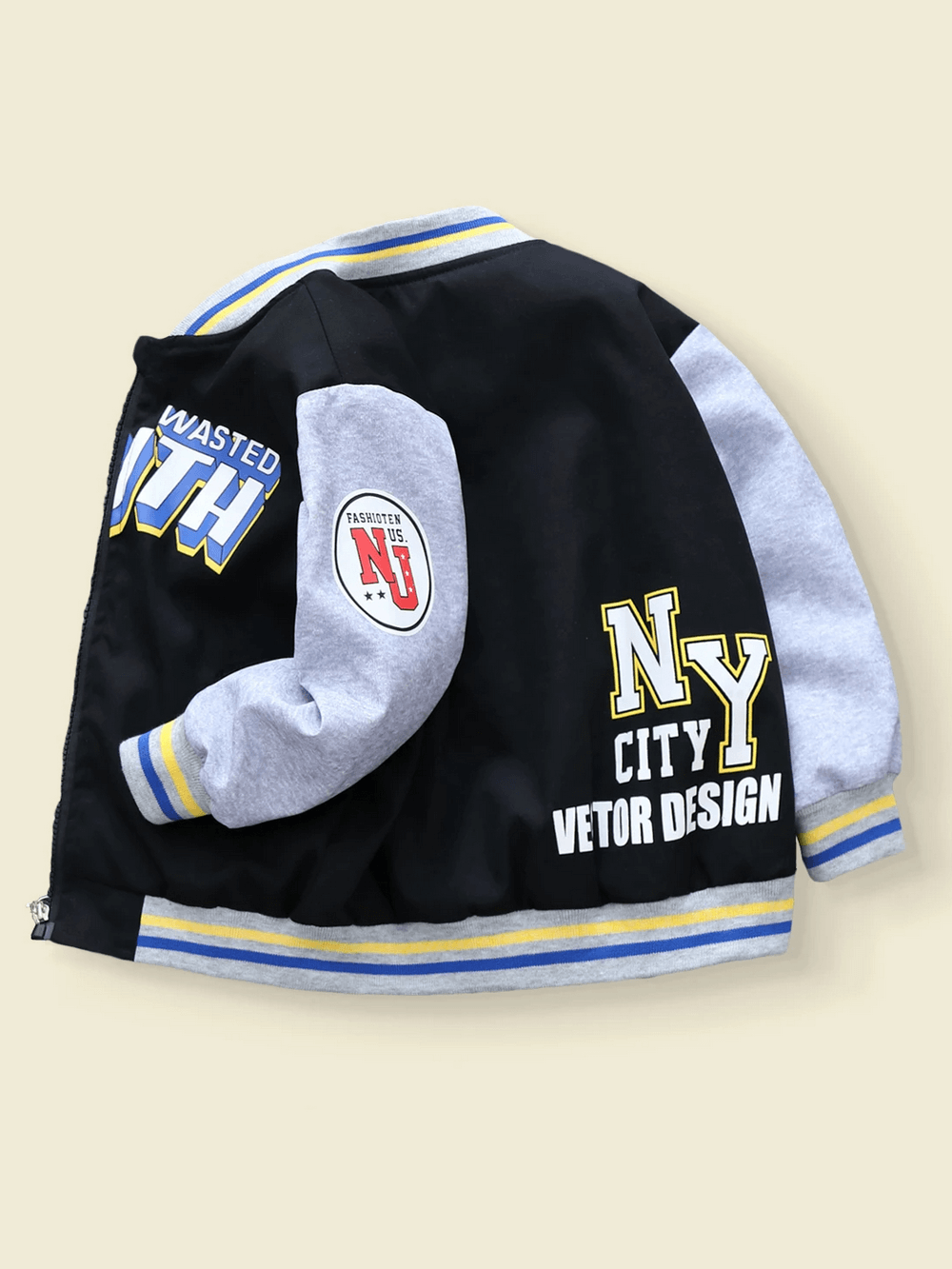 Trendy color-blocked kids baseball jacket with bold letter prints, showcasing a sporty varsity style. Perfect for active wear. Model SF3118