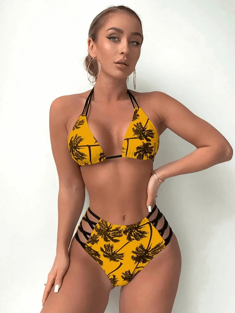 Tropical print bikini set with palm design, high waist, and striped detail showcased by a model.