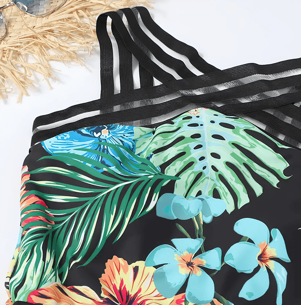 Tropical Print Cross Tape One Piece Swimsuit - SF4649 featuring vibrant leaf and floral patterns with stylish cross-front straps.