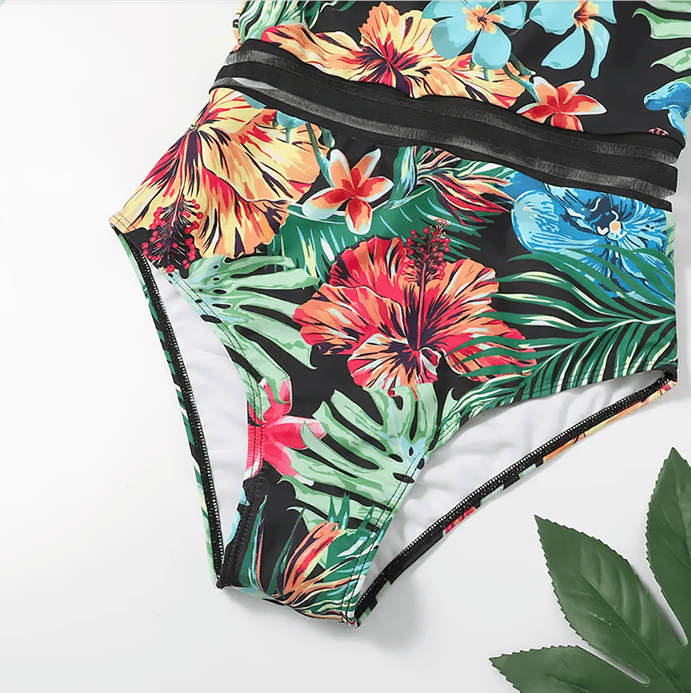 Tropical Print Cross Tape One Piece Swimsuit - SF4649 featuring vibrant floral and leaf patterns with mesh tape details.