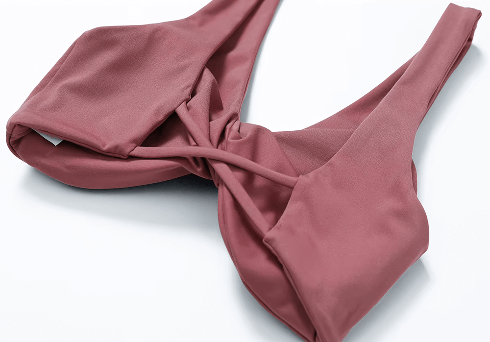 Twist-front backless sports bra in pink, perfect for fitness, yoga, or running. Breathable, quick-dry fabric ensures comfort and support.