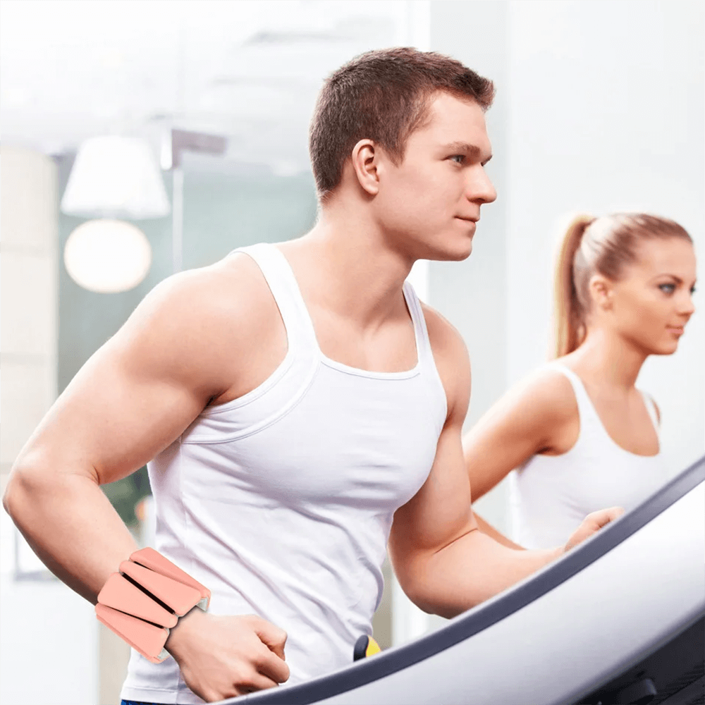 Man jogging on treadmill wearing two-color silicone fitness bracelet weights.