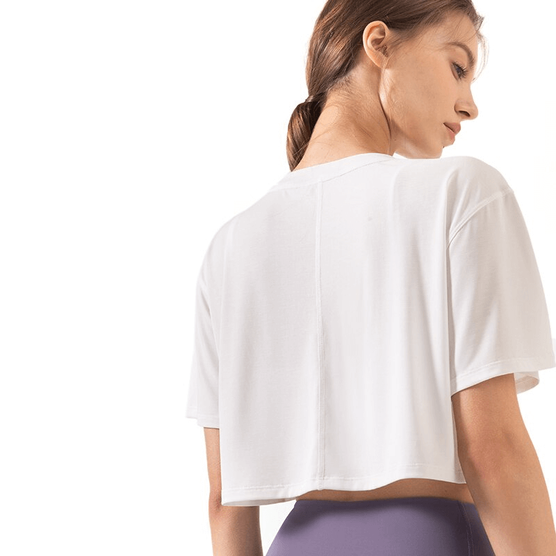 Woman wearing Ultralight Elastic Breathable Short Sleeves Gym Fitness T-Shirt, white, showing back view with O-neck.