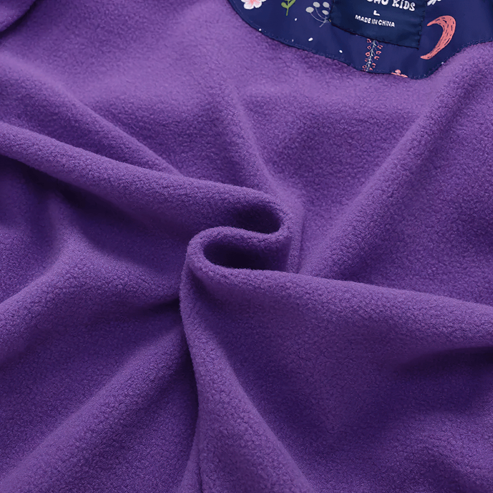 Close-up of purple soft fabric used in Unicorn Hooded Rain Jacket With Pockets For Girls - SF3609 showing texture and quality.