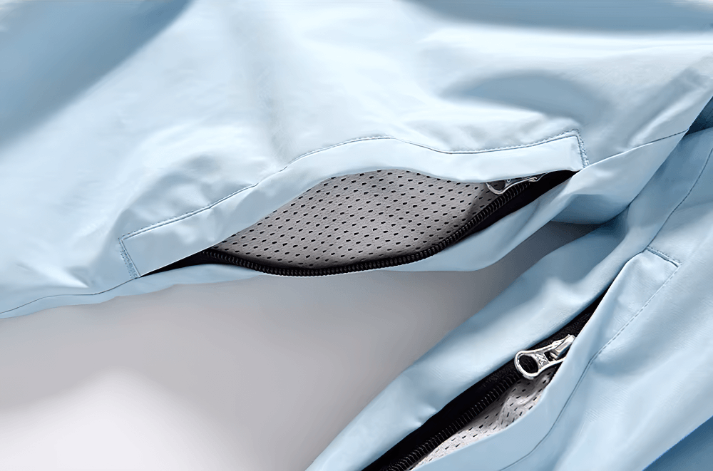 Detail of unisex breathable ski pants with zip pocket in light blue, showcasing durable and moisture-wicking design.