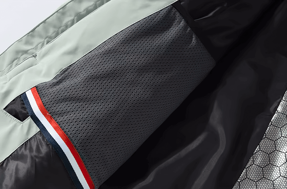 Close-up of the breathable lining inside a unisex skiing jacket, featuring durable polyester and moisture control fabric.