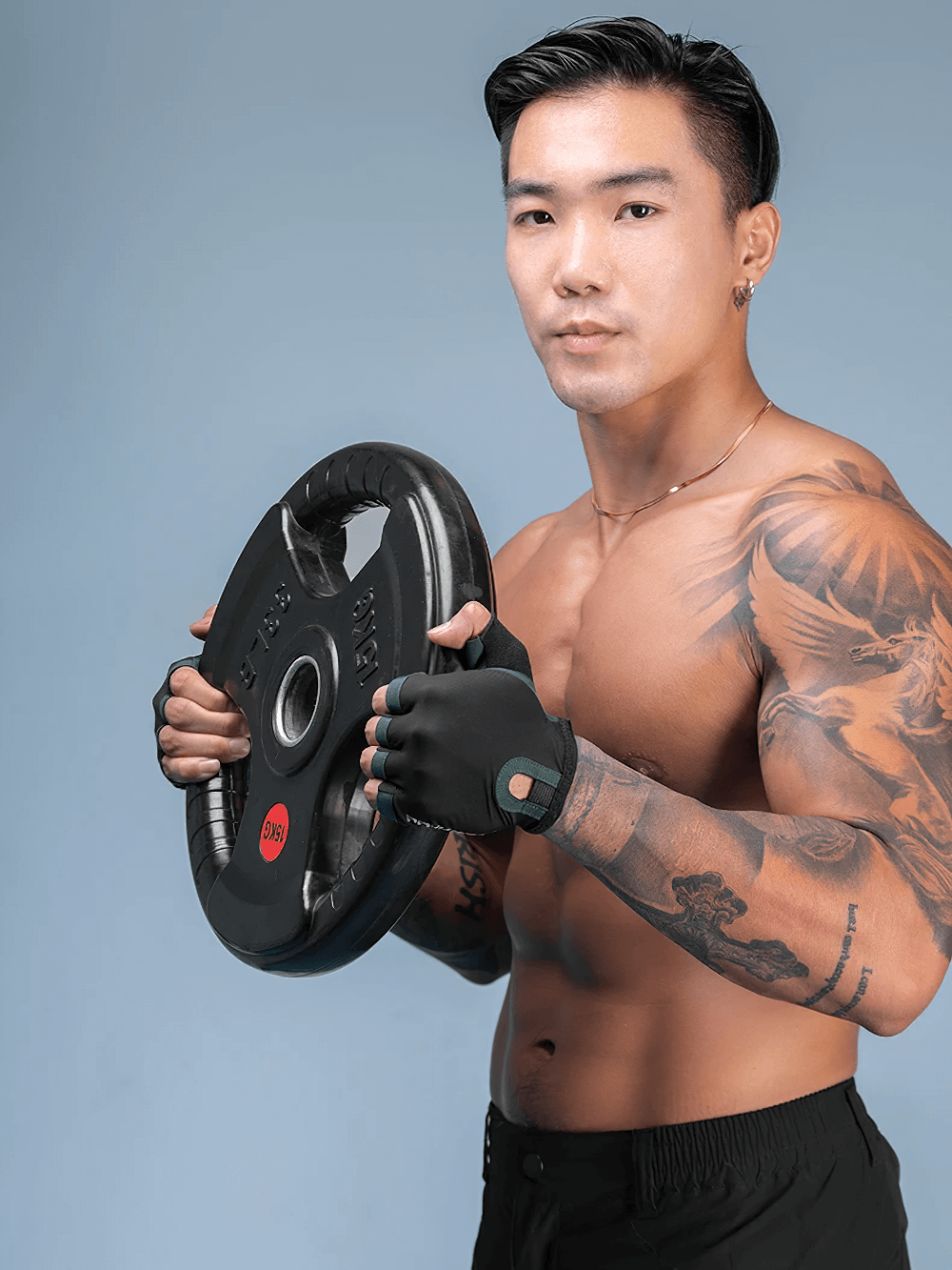 Man wearing half-finger cycling gloves holding a weight plate, showcasing efficient grip and breathability for workout.