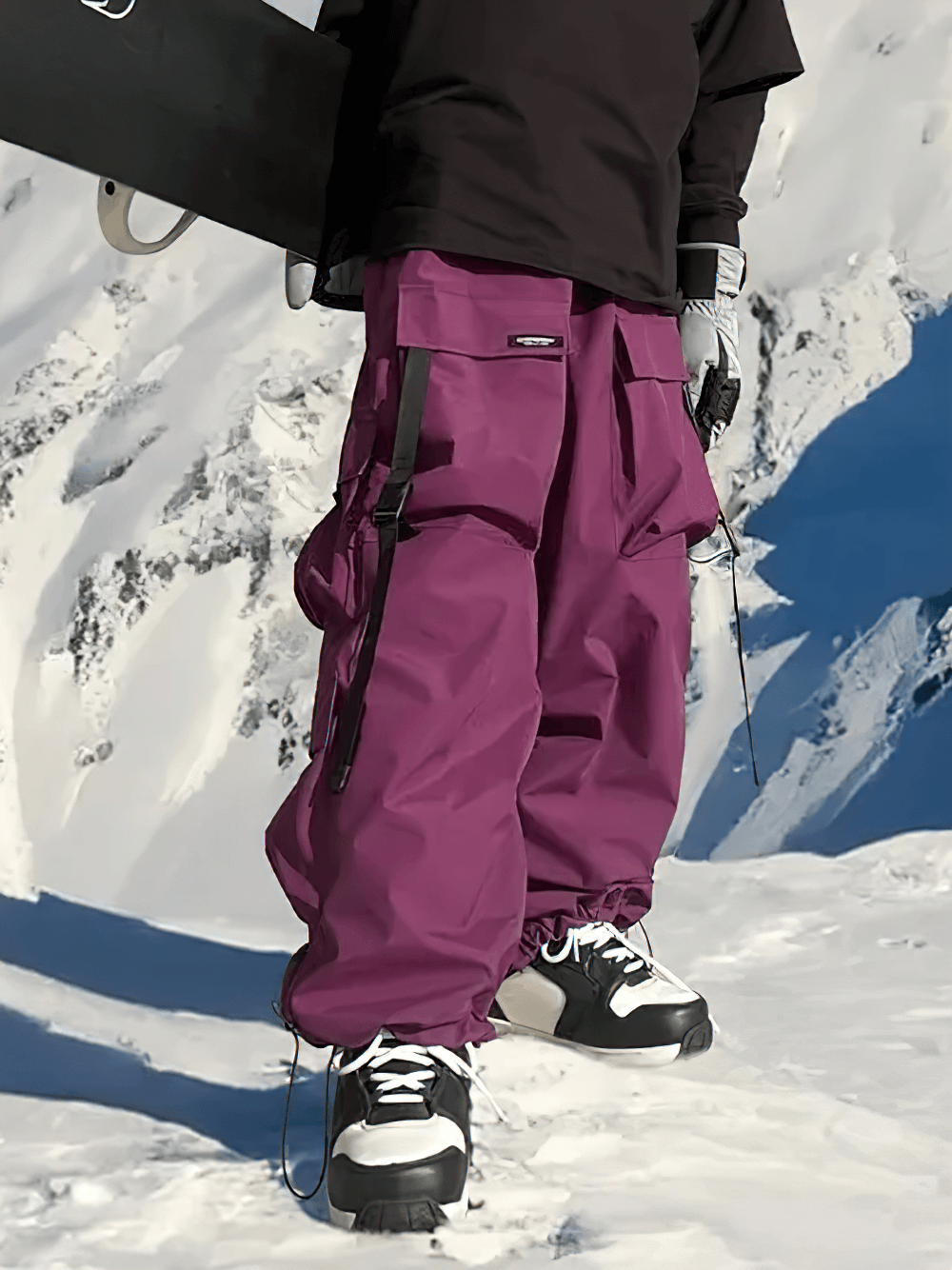 Unisex Multi-Pocket Waterproof Ski Snowboard Pants - SF4245 in action, featuring purple baggy style with snow-covered mountain backdrop.