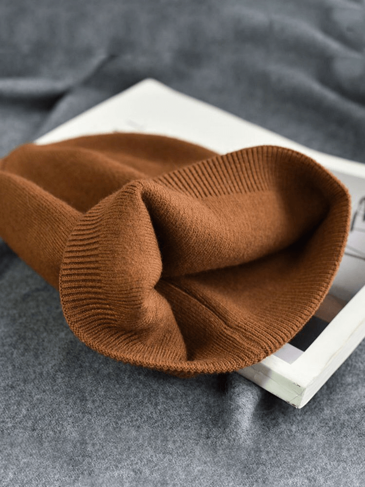 Unisex solid color cashmere beanie in rich brown, 100% wool, perfect for casual winter wear. SF1476 headwear on display.