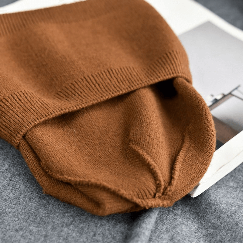 Unisex solid color cashmere warm beanie in brown, crafted from 100% wool, showcasing its snug fit and casual style on a neutral background.