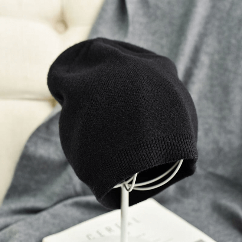 Unisex solid color cashmere beanie in black, perfect for winter warmth and casual style with 100% wool material.