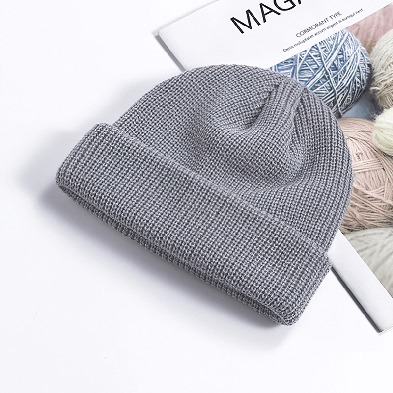 Unisex solid color grey knitted brimless hat on magazine, perfect for keeping warm. Made from soft cotton. Suitable for men and women.