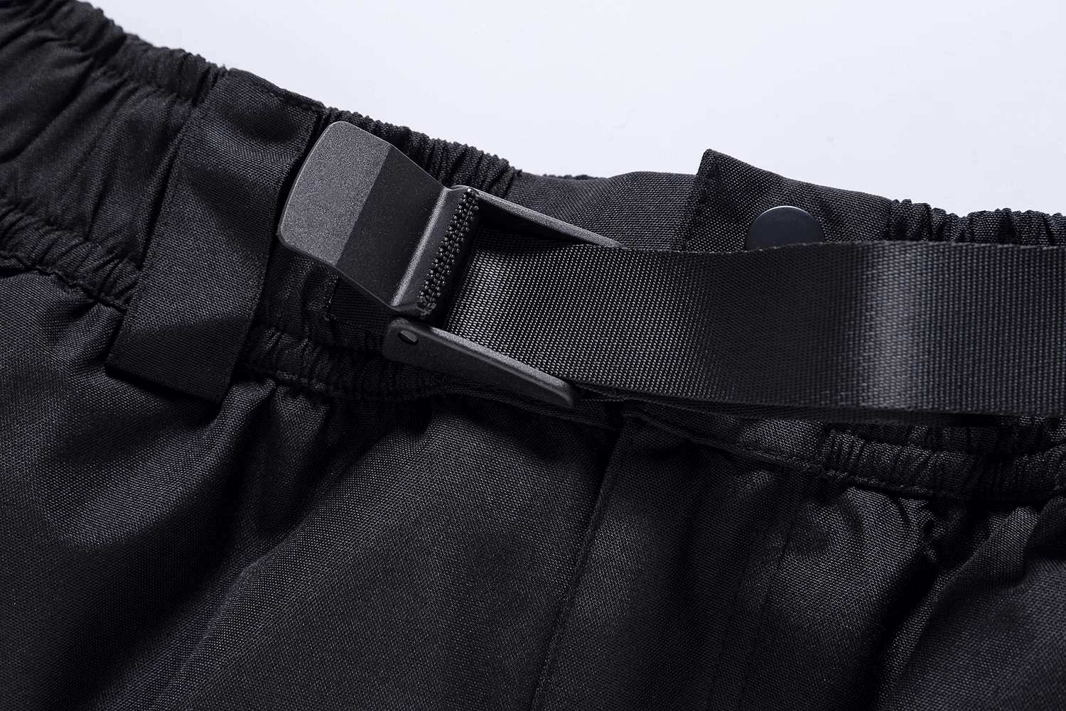 Close-up of adjustable black belt on unisex waterproof ski pants, SF2257, offering secure fit for extreme winter sports.