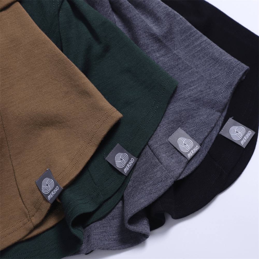 Colorful merino wool balaclavas neatly arranged, showcasing black, gray, green, and brown variations for versatile unisex outdoor use.