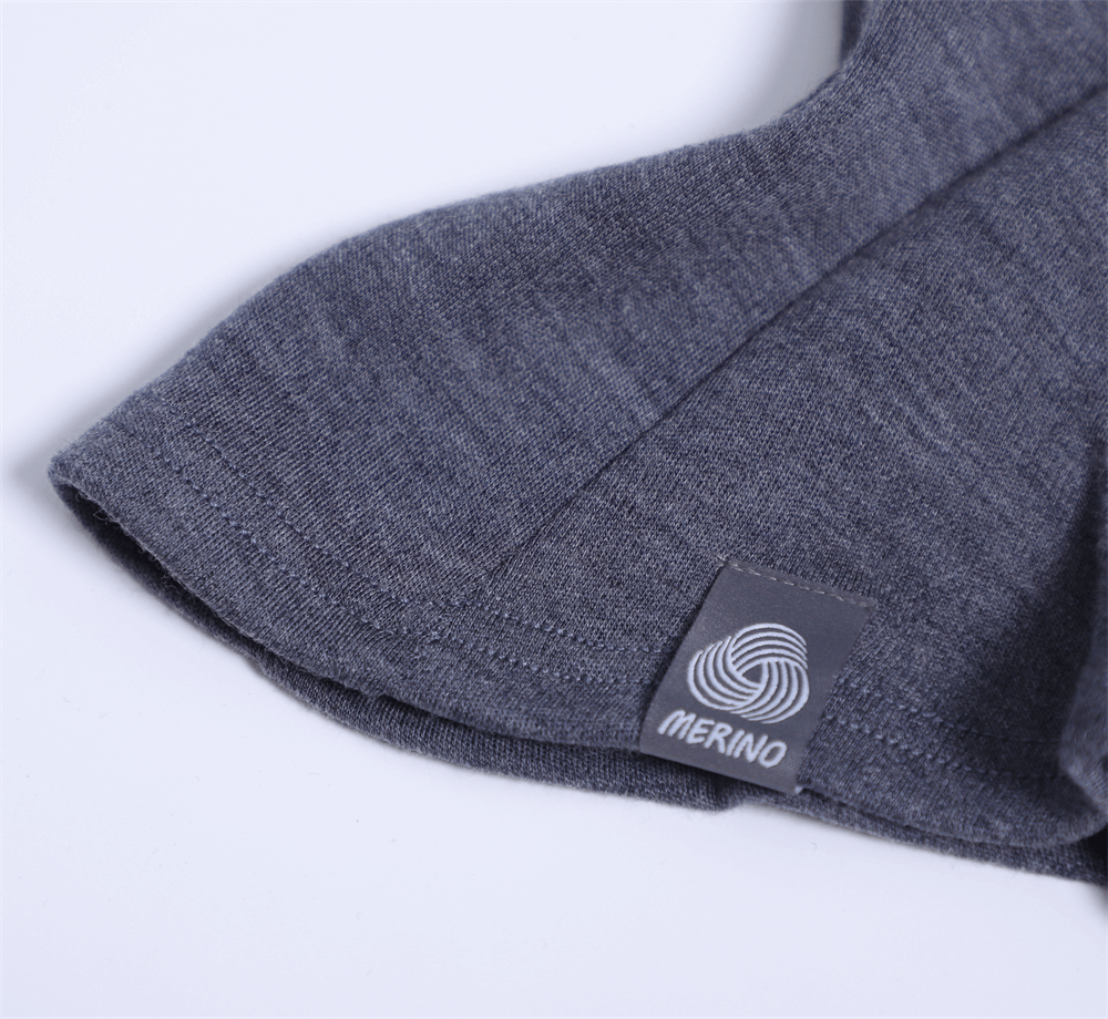 Close-up of grey merino wool fabric with label, showcasing texture and quality of unisex windproof breathable balaclava.