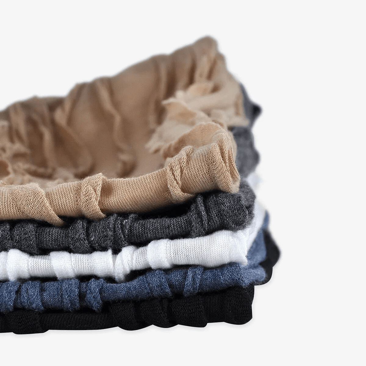 Stack of unisex windproof warm baggy solid beanies in various colors, showcasing lightweight cotton blend material.