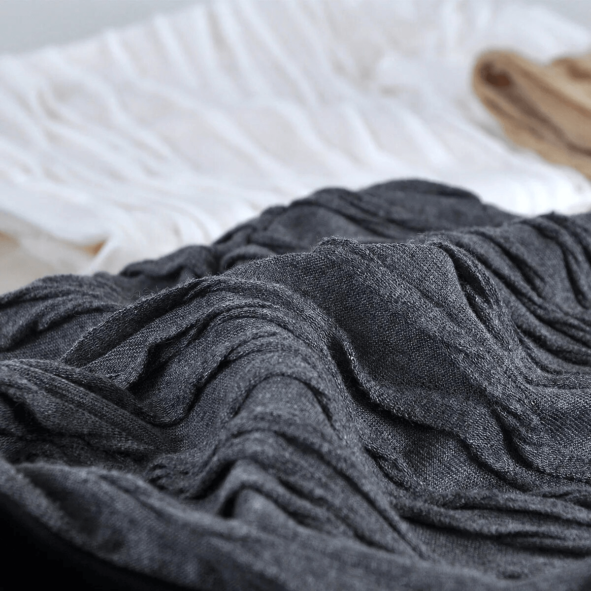 Close-up of a textured, windproof, warm baggy solid beanie in dark fabric, showcasing its cotton material and unisex design.