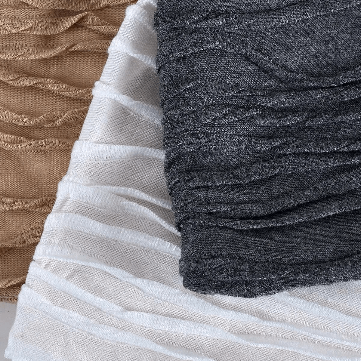 Three textured fabrics in beige, white, and grey with a ruffled design, showcasing soft cotton material for versatile styling.