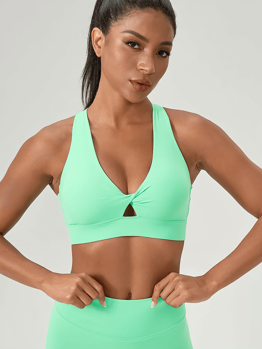 Model wearing V-Neck Twist Front Sports Bra with Racerback Design - SF4043 in mint green