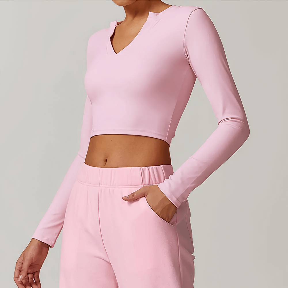 Pink V-Neck Yoga Long Sleeve Crop Top for Women, perfect for running and fitness, featuring breathable, stretchable fabric.